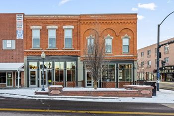 A red brick building with a signature